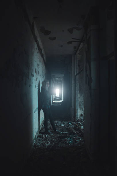 istock Young woman standing in dark hall horror concept 1277771417