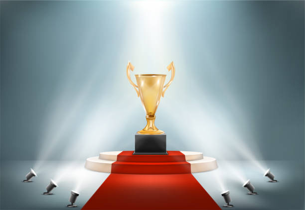 istock golden award cup on pedestal with spotlights light vector illustration 1277771427