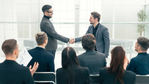 istock happy colleagues shaking hands with each other 1277772744