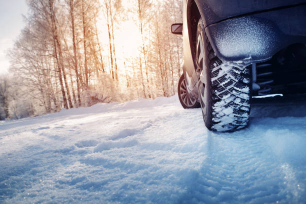 istock Car tires on winter road covered with snow 1277772829