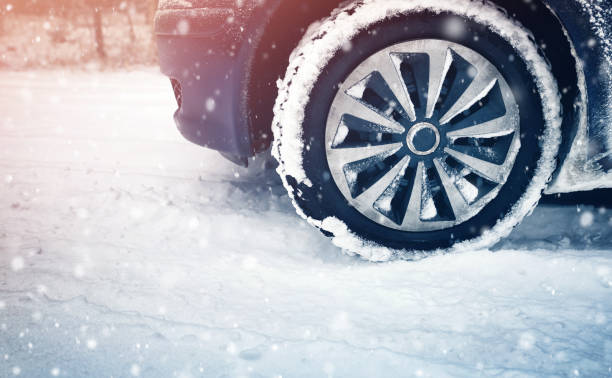 istock Car tires on winter road covered with snow 1277772850