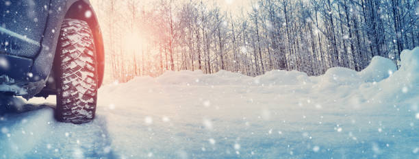 istock Car tires on winter road covered with snow 1277772865
