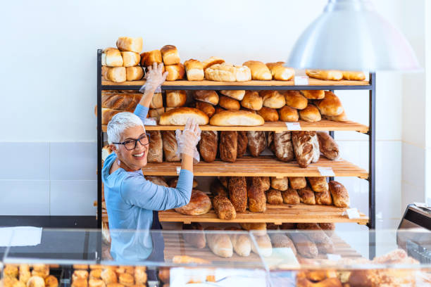 istock Female bakery worker behind the counter ready to service 1277772955