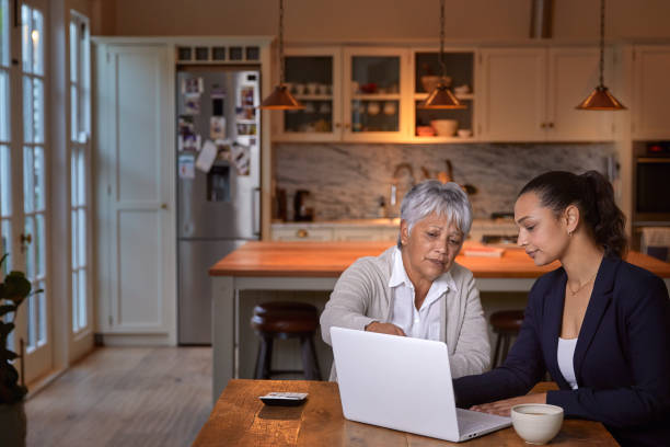 Let's get your finance in order Shot of senior woman having a consultation with a financial advisor at home claim form stock pictures, royalty-free photos & images
