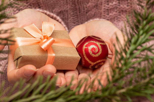 istock hands in a knitted sweater holding gift present box. Christmas holidays preparation concept. 1277775529