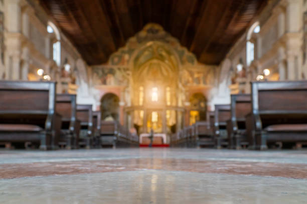 istock Blurred architecture background of church interior inside old cathedral catholic holy pray god jesus religion with candles 1277776219