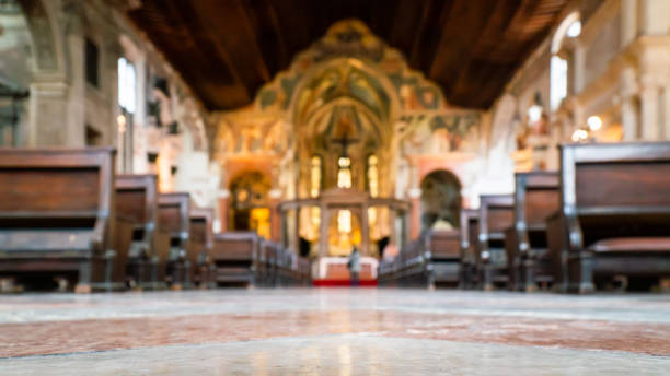 istock Blurred architecture background of church interior inside old cathedral catholic holy pray god jesus religion with candles 1277776222