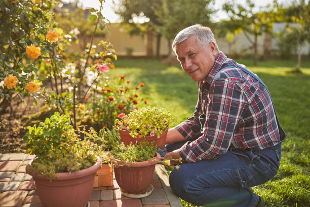 istock Enthusiastic gardener posing beside his potted plants 1277777570