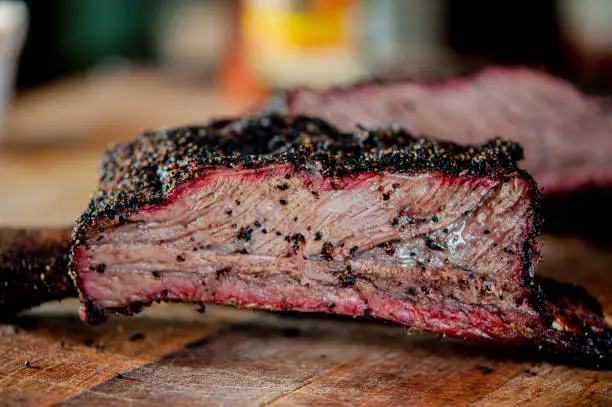 Beef ribs. Barbecue table spread. Beef brisket, chicken, pork ribs, beef ribs, Mac n cheese, cornbread, Brussels sprouts, coleslaw & beer. Classic traditional Texas meats & side dishes.