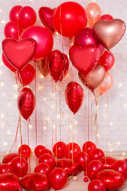 istock Valentine's day background - red balloons over brick wall 1277777987
