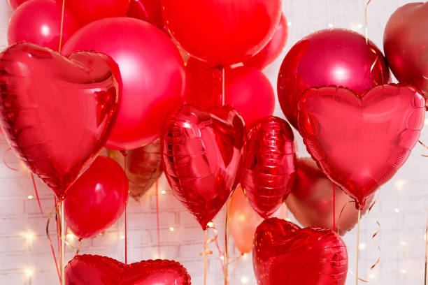 istock Valentine's day background - red heart shaped balloons over brick wall 1277777990
