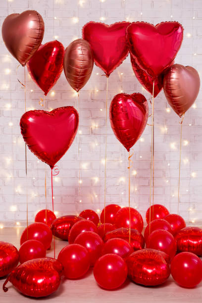 istock Valentine's day background - group of red balloons over brick wall 1277778012