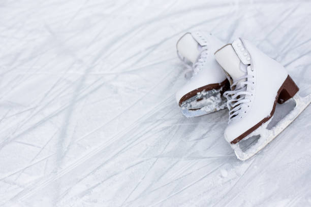 istock figure skates over ice background with marks from skating or hockey 1277778062