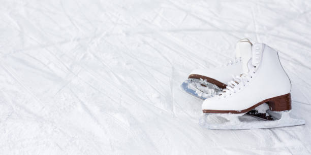 istock white figure skates and copy space over ice background with marks from skating 1277778064