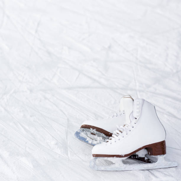 istock figure skates and copy space over ice with marks from skating 1277778070