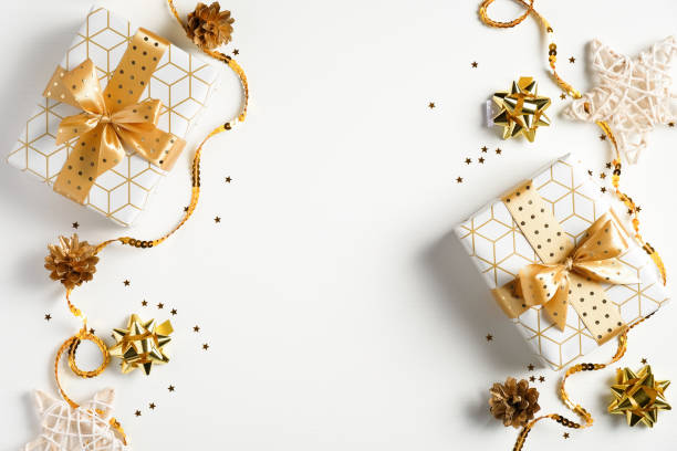 istock Flat lay Christmas composition. Top view gift boxes, golden decorations, ribbons, confetti on white background. Christmas, winter holidays, New Year concept 1277780855