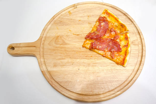 istock Slice peperoni pizza left on wooden platter 1277782896
