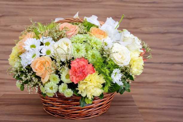 istock flowers in basket on wooden background 1277782974