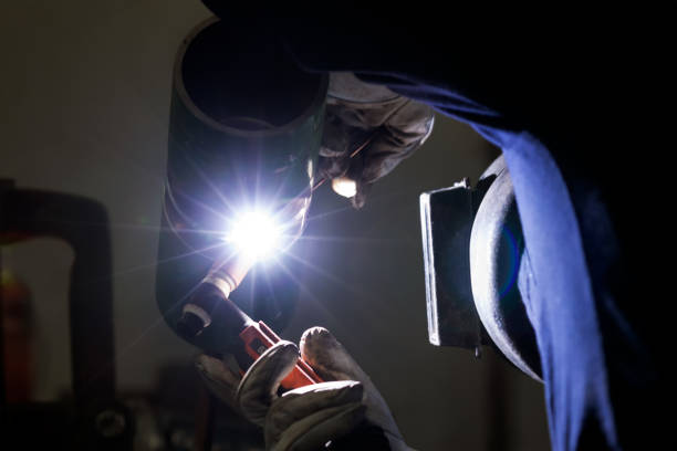 The welder is welding to pipe for welder qualification with gas tungsten arc welding method (Test position: 6G or H-L045). The welder is welding to pipe for welder qualification with gas tungsten arc welding method (Test position: 6G or H-L045). argon stock pictures, royalty-free photos & images