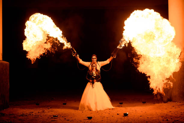 istock Halloween couple standing with flamethrower in hands. big fire 1277785302