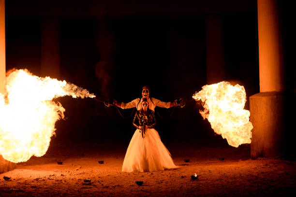 istock Halloween couple standing with flamethrower in hands. big fire 1277785304