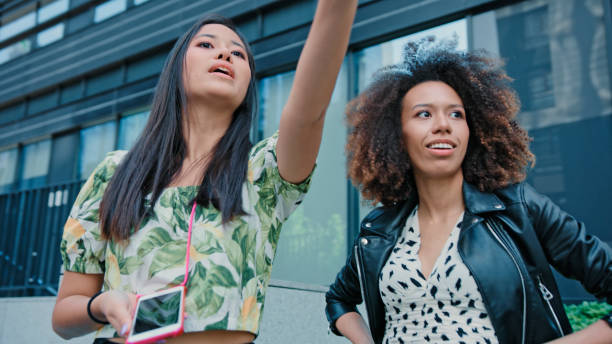 istock Multi ethnic friends catching an Uber in the city center. Using mobile app 1277788210