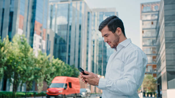 istock Elegant man catching an Uber in the city center. Using mobile app 1277788393