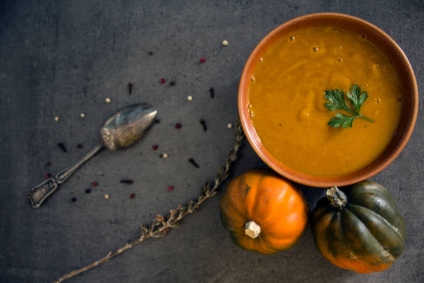 Creamy pumpkin soup on a table.