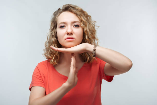istock Pretty Young blonde woman doing time-out gesture with hands. Studio shot, white background. Facial expression concept 1277796537