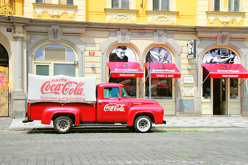 Prague, Czech Republic - June 06, 2016: An old renovated 1930- 1940s Coca-Cola red delivery pickup truck 1934 Ford parking on the Prague street in Prague, Czech Republic