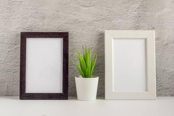 istock Two empty photo frames on a table or shelf with a copy of the space 1277800784
