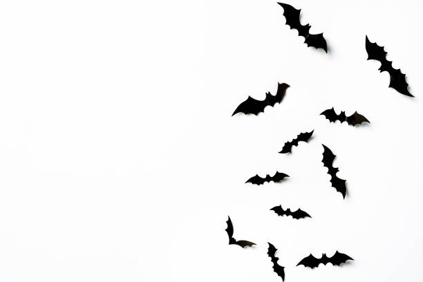istock Flying bats group isolated on white background.  Halloween symbols. 1277802694