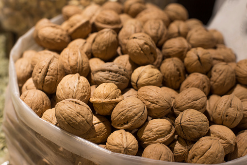 Walnuts with and without shells. Background of fresh walnuts