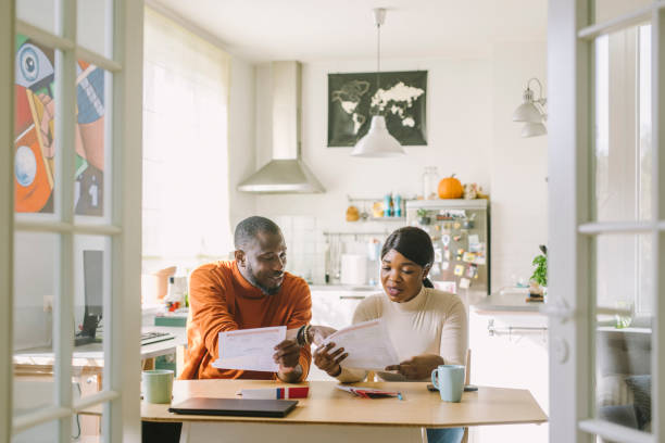 istock Couple reading mail-in voting ballot at home 1277806171