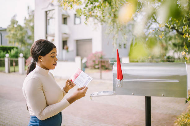 istock African-American woman receiving voting envelope 1277806197
