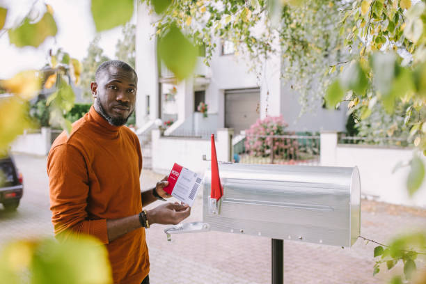istock Man with mail-in voting ballot 1277806198