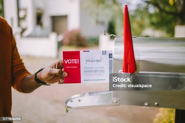 Man Putting Voting Ballot To Mailbox Stock Photo - Download Image Now - Voting by Mail, Mailbox, Mail