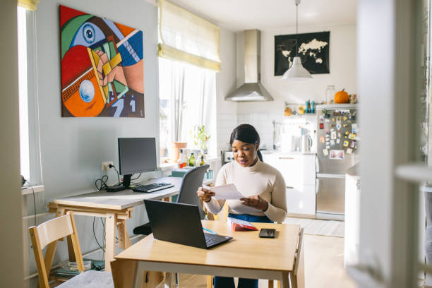 istock Woman reading voting ballot at home 1277806206