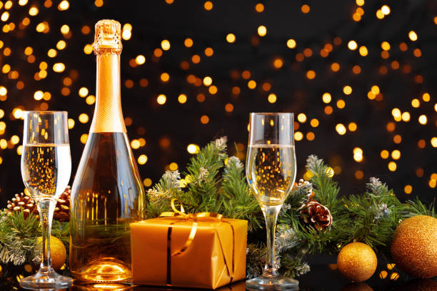 istock Champagne bottle and glasses on blurred lights background 1277806352