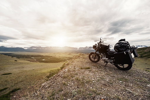 A BMW motorcycle faces the snowy Rocky Mountains