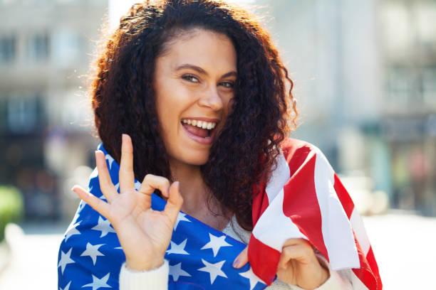 istock Young woman holding the American flag 1277809965