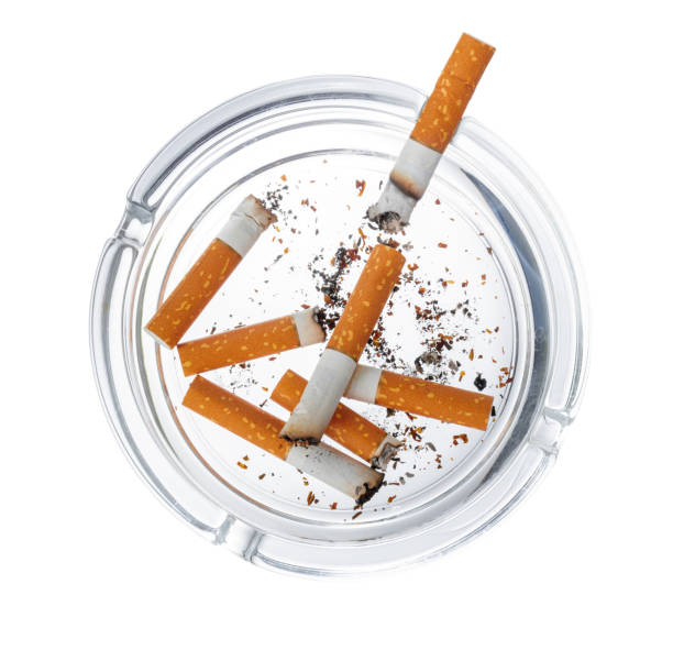 istock Burnt cigarette butts in an ash tray isolated on white 1277811883