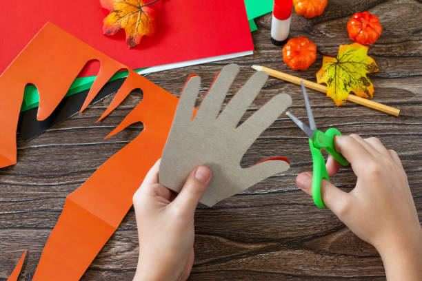 istock Instructions, step 3. Greeting card halloween on wooden table. Children's creativity project, crafts, crafts for kids. 1277812205