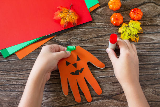 istock Instructions, step 5. Greeting card halloween on wooden table. Children's creativity project, crafts, crafts for kids. 1277812206