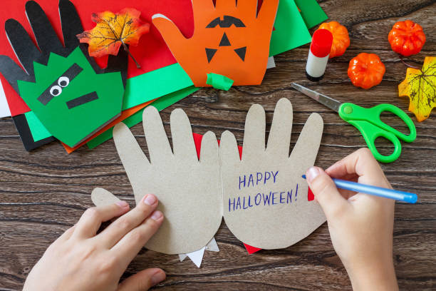 istock Instructions, step 14. Greeting card halloween on wooden table. Children's creativity project, crafts, crafts for kids 1277812225