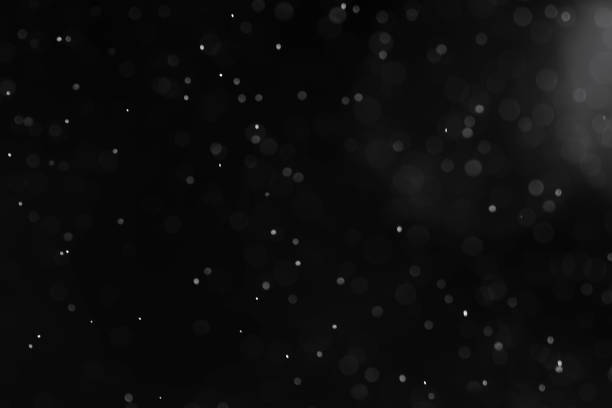 istock Silver bokeh defocus dark abstract background. Silver festive Christmas lights. Glitter twinkled black and white background 1277814567