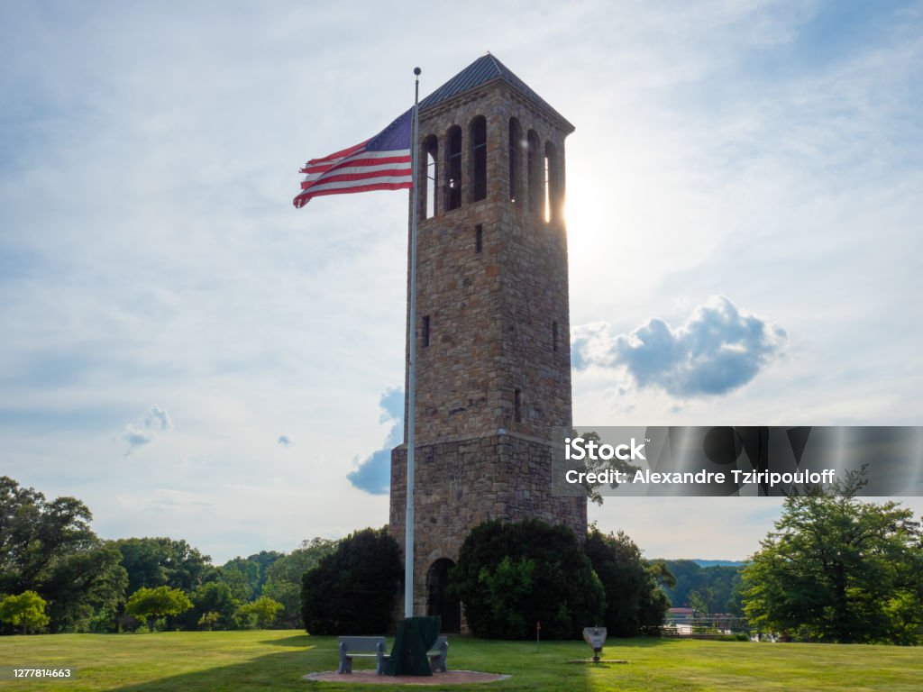 Luray Singing Tower. Stars and stripes waving next to the Singing Tower in Luray, Virginia. Virginia - US State Stock Photo