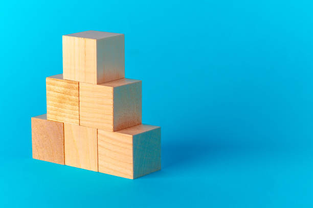 istock Toy wooden blocks on blue background front view 1277814753