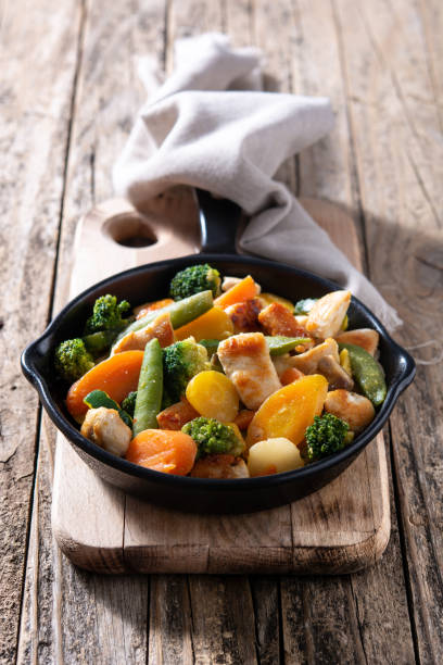 istock Stir fry chicken with vegetables on iron pan 1277817753