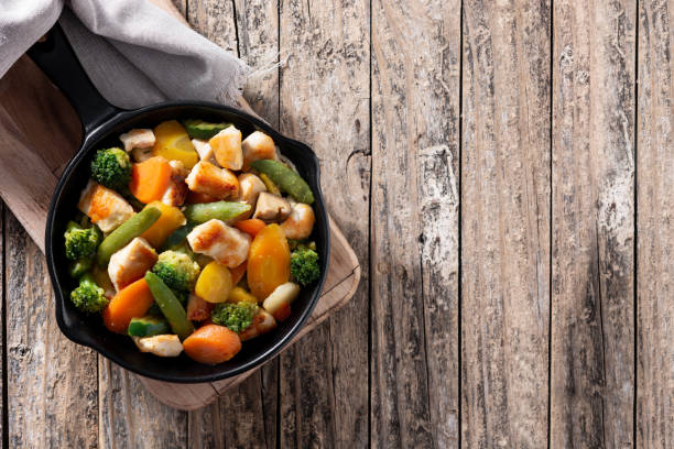 istock Stir fry chicken with vegetables on iron pan 1277817913